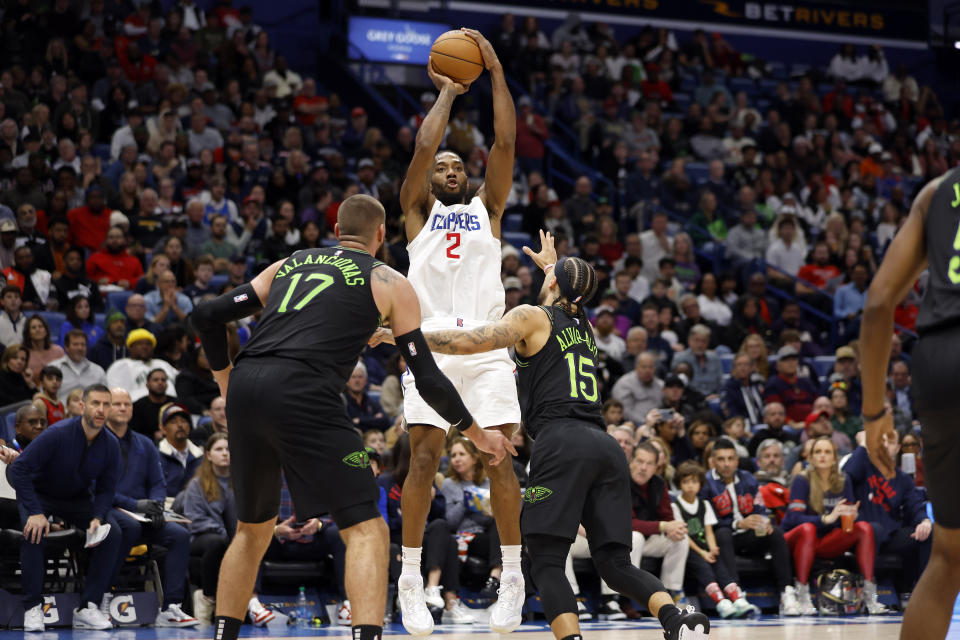 Los Angeles Clippers forward Kawhi Leonard (2) looks to shoot over New Orleans Pelicans guard Jose Alvarado (15) and center Jonas Valanciunas (17) in the first half of an NBA basketball game in New Orleans, Friday, Jan. 5, 2024. (AP Photo/Tyler Kaufman)
