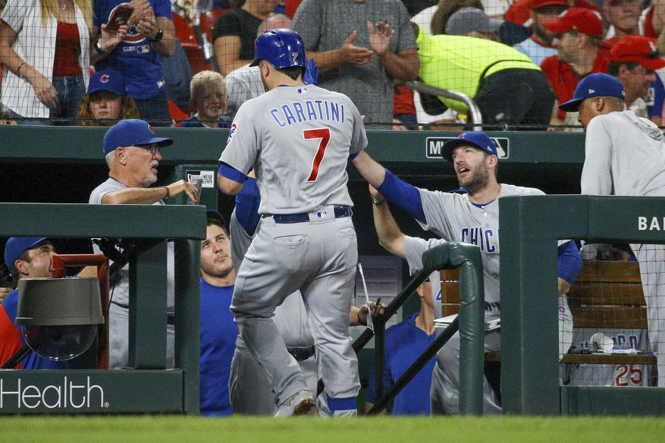 Chicago Cubs' Victor Caratini is congratulated by teammates as he enters the dugout after hitting a solo home run during the fifth inning of a baseball game against the St. Louis Cardinals, Saturday, Sept. 28, 2019, in St. Louis. (AP Photo/Scott Kane)