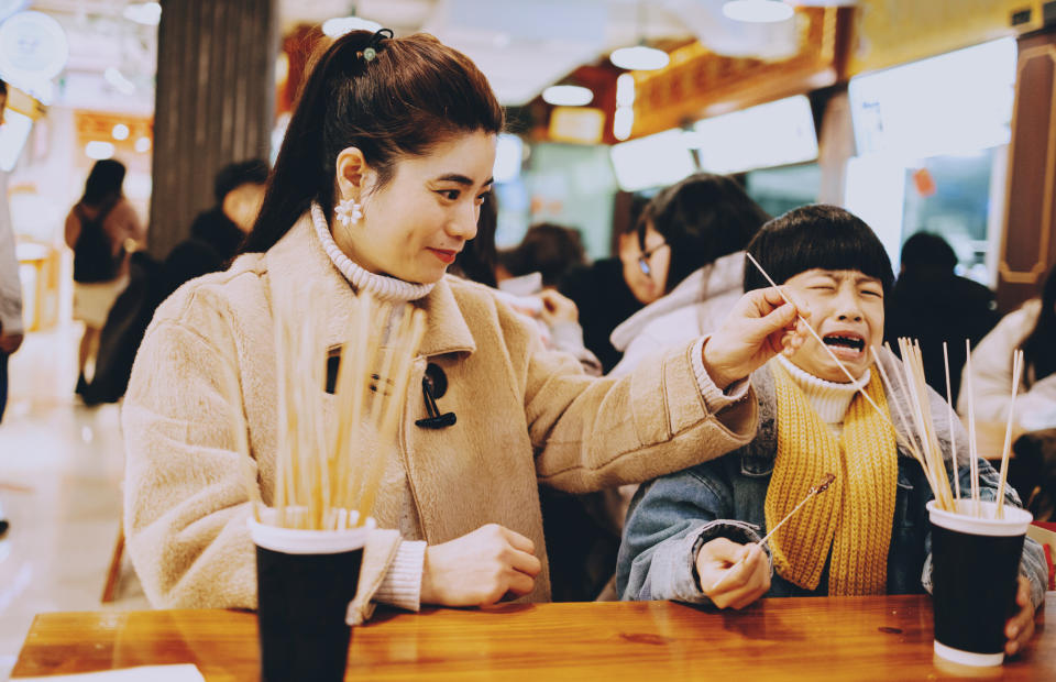 parent next to crying child in restaurant