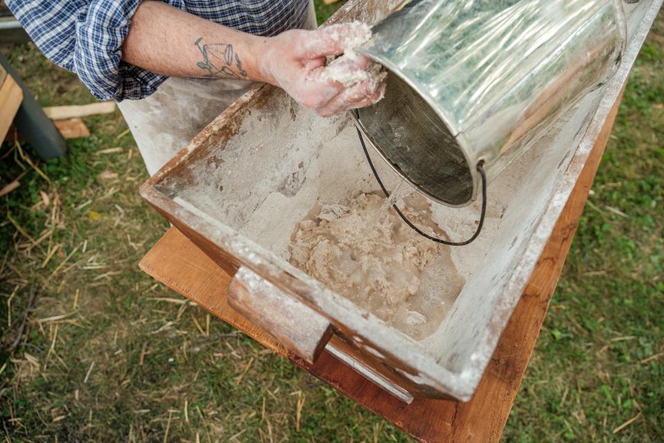 Jeff Pavlek, from Mt. Clemens, Michigan, prepares a bread recipe during annual Revolutionary War reenactments, Saturday, at Fort Laurens in Lawrence Township.