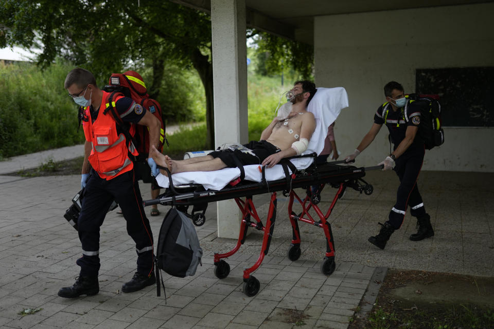 A man on hunger strike is transferred to a hospital as he occupies with others a big room of the ULB Francophone university in Brussels, Tuesday, June 29, 2021. More than two hundreds of migrants without official papers and who have been occupying a church and two buildings of two Brussels universities since last February, began a hunger strike on 23 May to draw the attention of Brussels authorities to their plight. (AP Photo/Francisco Seco)