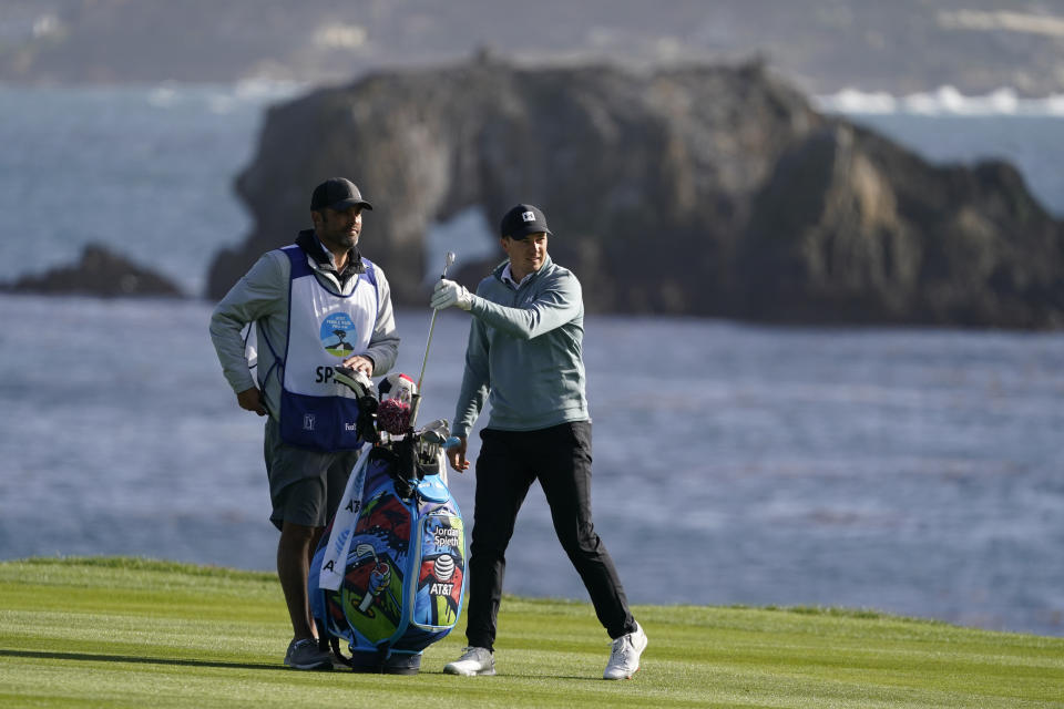 Jordan Spieth puts a club back in his bag after hitting from the 18th fairway of the Pebble Beach Golf Links during the third round of the AT&T Pebble Beach Pro-Am golf tournament Saturday, Feb. 13, 2021, in Pebble Beach, Calif. (AP Photo/Eric Risberg)