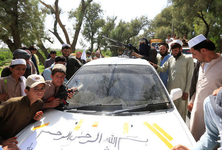 People gathered Taliban as they celebrate ceasefire in Bati Kot district of Nangarhar province, Afghanistan June 16, 2018. REUTERS/Parwiz