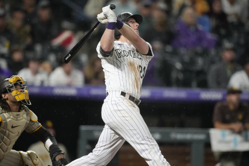 Colorado Rockies' Ryan McMahon follows the flight of his three-run home run against San Diego Padres relief pitcher Steven Wilson in the seventh inning of a baseball game Tuesday, Aug. 1, 2023, in Denver. (AP Photo/David Zalubowski)