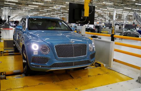 A worker drives a Bentley SUV on a rolling road at their factory in Crewe, Britain January 22, 2019. REUTERS/Phil Noble