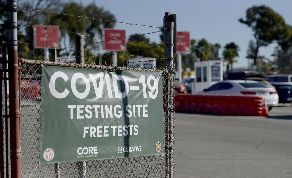 A sign indicates that COVID-19 testing is being held, outside Dodger Stadium on Tuesday, Nov. 17, 2020, in Los Angeles. (Dean Musgrove/The Orange County Register via AP)