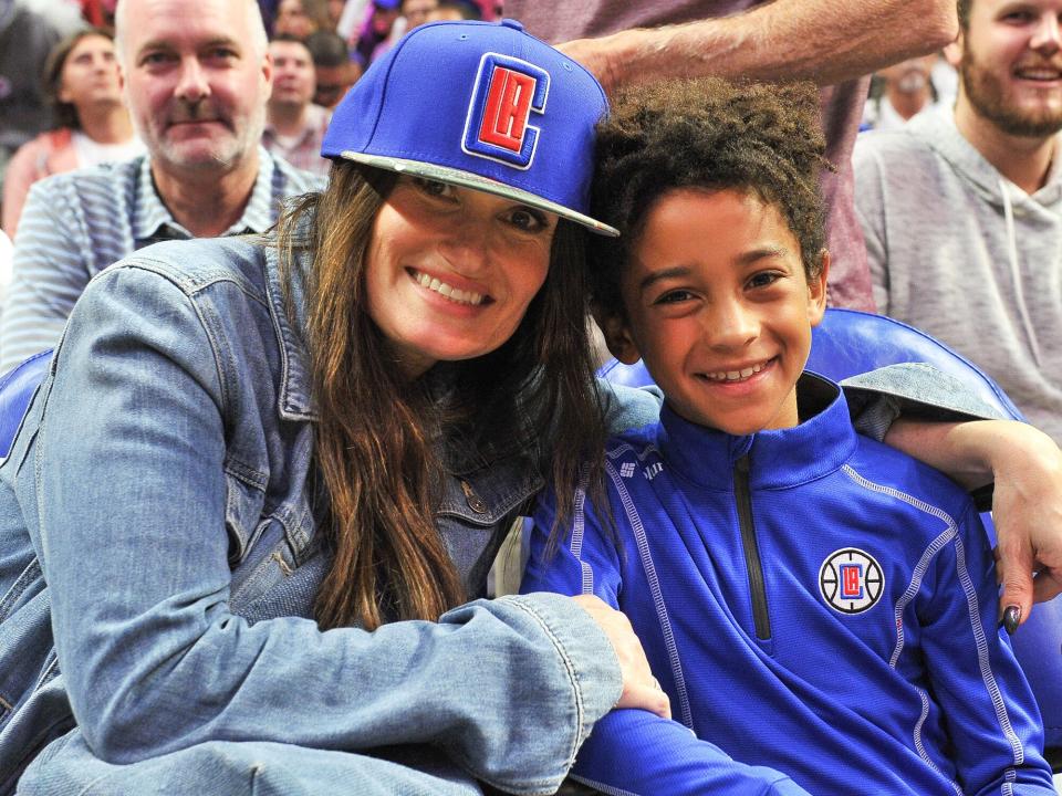 Idina Menzel and Walker Nathaniel Diggs attend a basketball game between the Los Angeles Clippers and the Charlotte Hornets at Staples Center on October 28, 2019 in Los Angeles, California