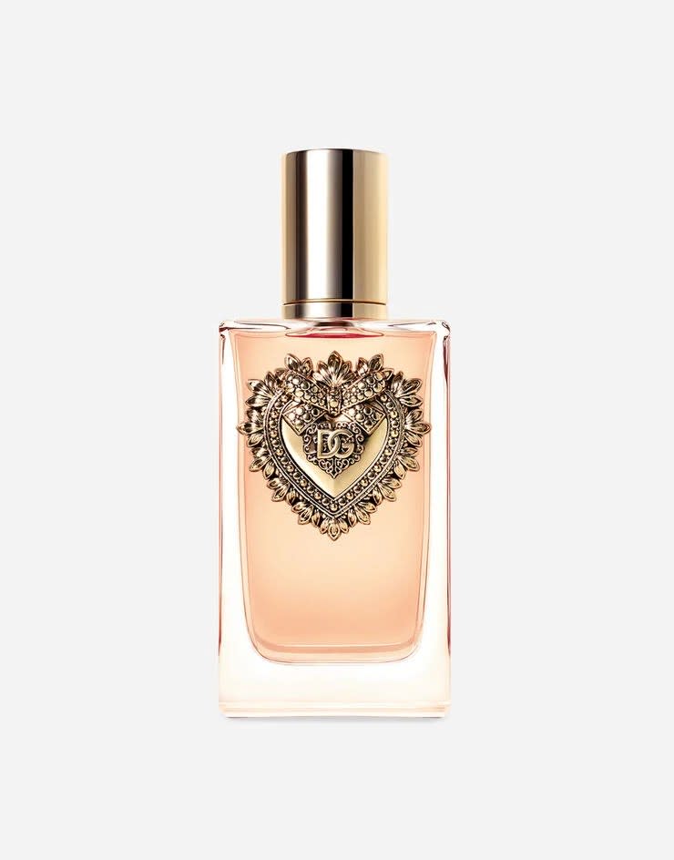 clear and gold bottle of perfume with gold emblem in the front