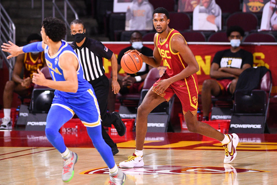 Evan Mobley dribbles the ball up the court.