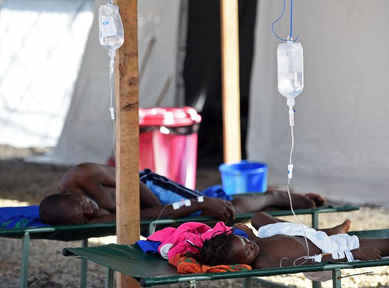 Patients lie on stretchers at the Ebola Kenema treatment centre in eastern Sierra Leone, run by the Red Cross Society, on November 15, 2014