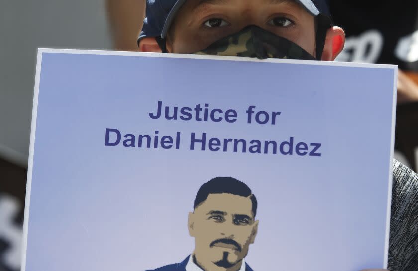 LOS ANGELES, CALIF. - JUNE 26, 2020. Matthew Hernandez, 8, holds a sign with a picture of his uncle, Daniel Hernandez, during a press conference at the L.A. County Hall of Justice on Friday, June 26, 2020. Daniel Hernandez was fatally shot by members of the LAPD in South Los Angeles. The Latino Coialition of Los Angeles is calling for complete and transparent investigations iof officers who have shot and killed Latinos and Blacks. (Luis Sinco/Los Angeles Times)