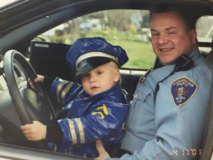 Brian Gillespie, as a Manasquan police officer in 2001, with his then-2-year-old son Brendan.