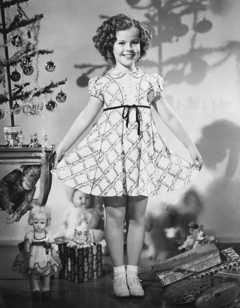 <p>The child actress strikes her classic pose while surrounded by countless toys and presents during the holidays. There's no denying she worked hard for those gifts!</p>