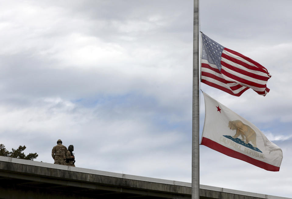 Flags fly at half-staff above the Santa Cruz County Courthouse on Friday, June 12, 2020 for Santa Cruz Sheriff's Deputy Sgt. Damon Gutzwiller as snipers guard during an arraignment for Gutzwiller's accused killer Steven Carrillo. (Shmuel Thaler/Santa Cruz Sentinel via AP)