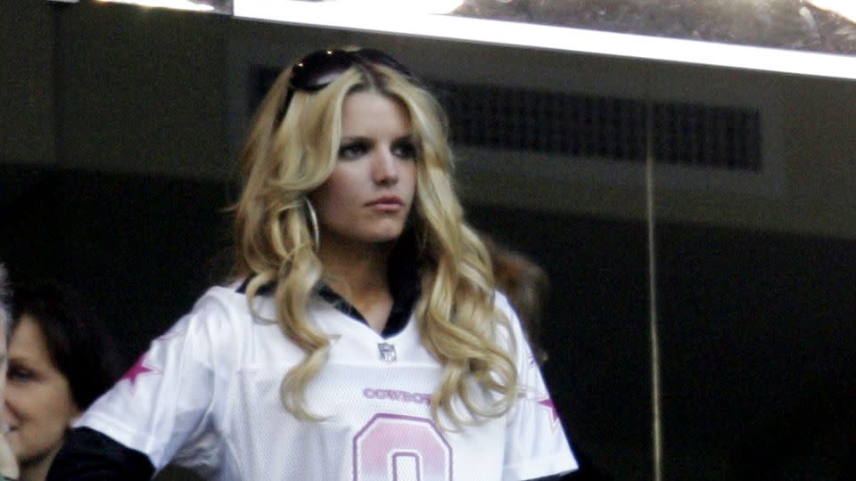 Jessica Simpson wears Dallas Cowboys quarterback Tony Romo's jersey number at a 2007 Eagles-Cowboys football game in Texas. - LM Otero/AP