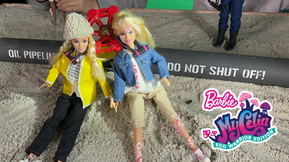 In the Yes Men hoax of a Barbie line, Greta Thunberg and Daryl Hannah lock themselves to an oil pipeline in protest. 
