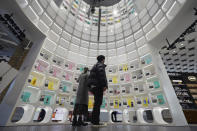 Visitors look at beauty products at @cosme TOKYO, a store selling a selection of cosmetics and makeup products including men's cosmetic, in Tokyo's Harajuku district Tuesday, Feb. 9, 2021. The coronavirus pandemic has been pushing businesses to the edge in Japan, but some in the men's beauty industry have seen an unexpected expansion in their customer base. Japanese businessmen in their 40s, 50s and 60s who had little interest in cosmetics before the pandemic are now buying makeup. (AP Photo/Eugene Hoshiko)