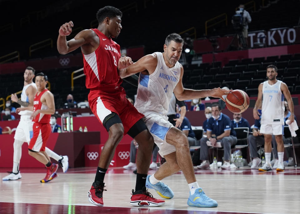 Argentina's Luis Scola (4) drives around Japan's Rui Hachimura (8) during men's basketball preliminary round game at the 2020 Summer Olympics, Sunday, Aug. 1, 2021, in Saitama, Japan. (AP Photo/Charlie Neibergall)