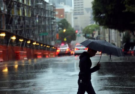 A pedestrian crosses an intersection in San Francisco, California December 11, 2014.REUTERS/Robert Galbraith