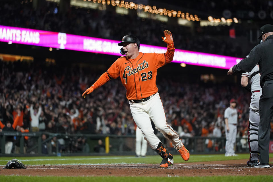 San Francisco Giants' Joc Pederson, who had hit a triple, reacts after scoring on a throwing error by Arizona Diamondbacks second baseman Josh Rojas during the second inning of a baseball game in San Francisco, Friday, Sept. 30, 2022. (AP Photo/Godofredo A. Vásquez)