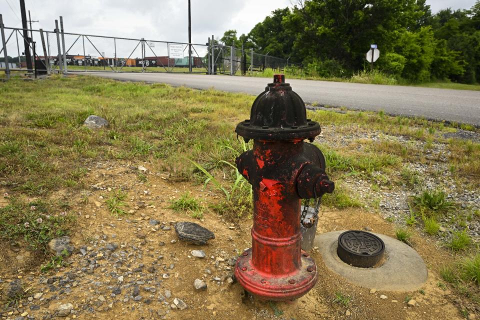 A water hydrant covered in black substance, stands at the entry to a Jack Daniels barrelhouse complex, Wednesday, June 14, 2023, in Mulberry, Tenn. A destructive and unsightly black fungus which feeds on ethanol emitted by whiskey barrels has been found growing on property near the barrelhouses. (AP Photo/John Amis)