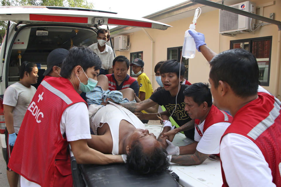 FILE - An injured anti-coup protester is brought for medical treatment to a hospital in Latha township, Yangon, Myanmar, Saturday, March 27, 2021. The prospects for peace in Myanmar, much less a return to democracy, seem dimmer than ever two years after the army seized power from the elected government of Aung San Suu Kyi, experts say. (AP Photo, File)