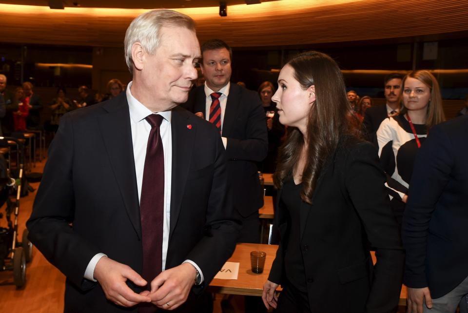 The candidate for the next Prime Minister of Finland, Sanna Marin, right, speaks with former Prime Minister of Finland Antti Rinnein Helsinki, Finland, Sunday, Dec. 8, 2019. A 34-year-old minister and lawmaker has been tapped to become Finland's youngest prime minister ever and its third female government head, replacing former Cabinet leader who resigned Tuesday. (Vesa Moilanen/Lehtikuva via AP)