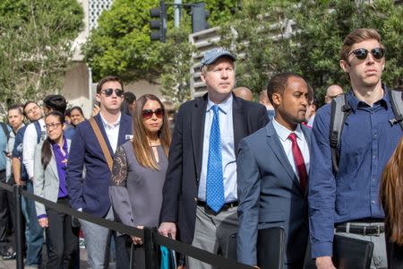 FILE PHOTO: Job seekers line up at TechFair in Los Angeles, California, U.S. March 8, 2018. REUTERS/Monica Almeida/File Photo