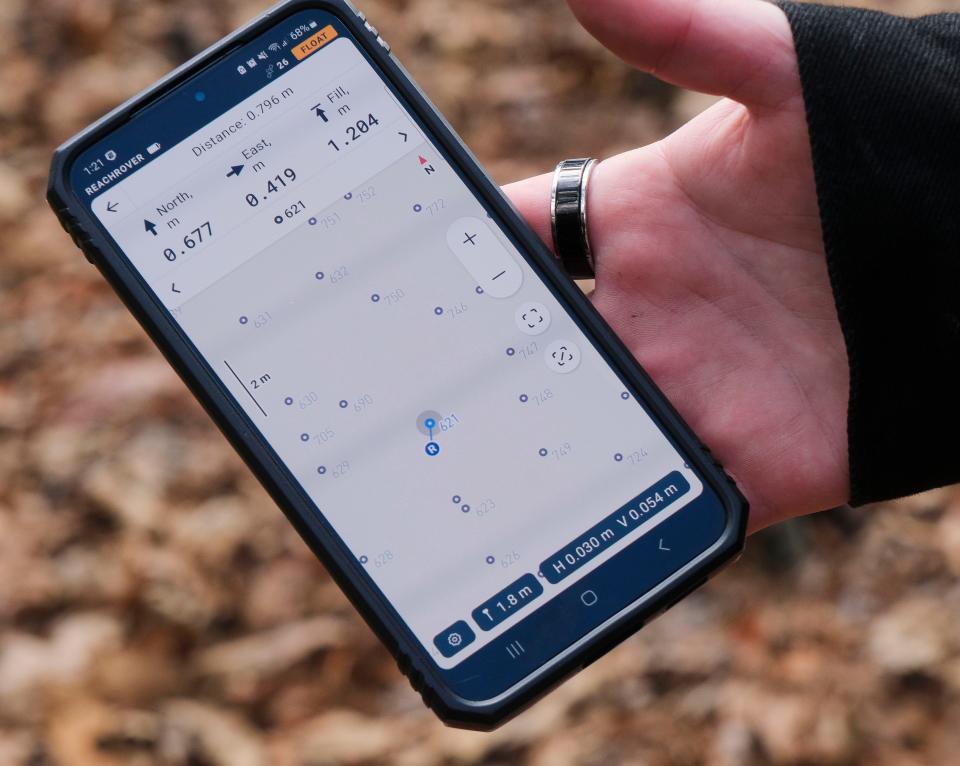 Students studying in the University of Alabama’s Anthropology Department mark previously located graves in the Prewitt Slave Cemetery in Tuscaloosa County Tuesday, Oct. 31, 2023. A GPS app on a cellphone directs students to the precise location of each discovered grave so it can be marked.