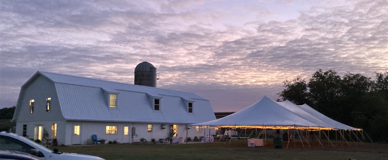 The Oconto Riviera venue is seen at dusk set up for a wedding and a reception in summer 2021.