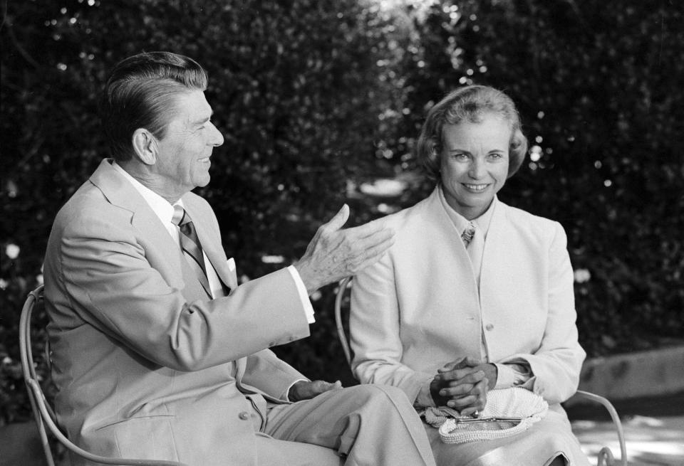 FILE - President Reagan presents his Supreme Court nominee Sandra Day O'Connor to members of the press in the White House Rose Garden, July 15, 1981, prior to their Oval Office meeting. O'Connor, who joined the Supreme Court in 1981 as the nation's first female justice, has died at age 93. (AP Photo, File)