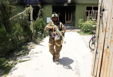 An Afghan security force personnel inspects a site after an attack in Jalalabad city, Afghanistan July 11, 2018. REUTERS/Parwiz