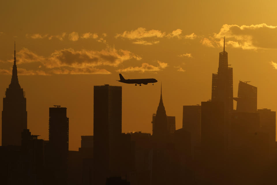 FILE - A plane flies with the New York City skyline, Thursday, Sept. 8, 2022, in New York. The ground rumbled Friday, April 5, 2024, beneath New York City, home to famous skyscrapers like the Empire State Building and One World Trade Center. Though buildings that can reach above 100 stories might seem especially vulnerable to earthquakes, engineering experts say they're built with enough flexibility to withstand them. (AP Photo/Julia Nikhinson, File)