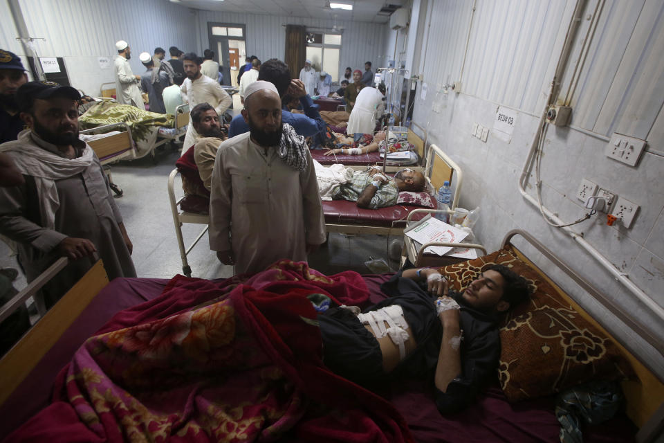 People who were injured in the clashes between police and supporters of Pakistan's former Prime Minister Imran Khan are treated at a hospital in Peshawar, Pakistan, Thursday, May 11, 2023. With former Prime Minister Imran Khan in custody, Pakistani authorities on Thursday cracked down on his supporters, arresting hundreds in overnight raids and sending troops across the country to rein in the wave of violence that followed his arrest earlier this week. (AP Photo/Muhammad Sajjad)