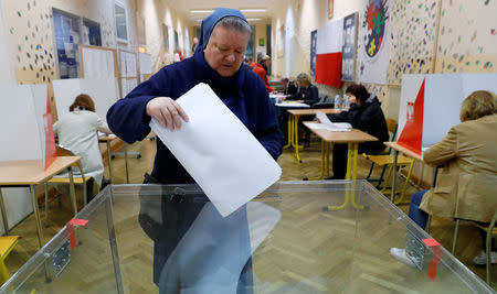 A nun casts her vote during the Polish regional elections, at a polling station in Warsaw, Poland, October 21, 2018. REUTERS/Kacper Pempel