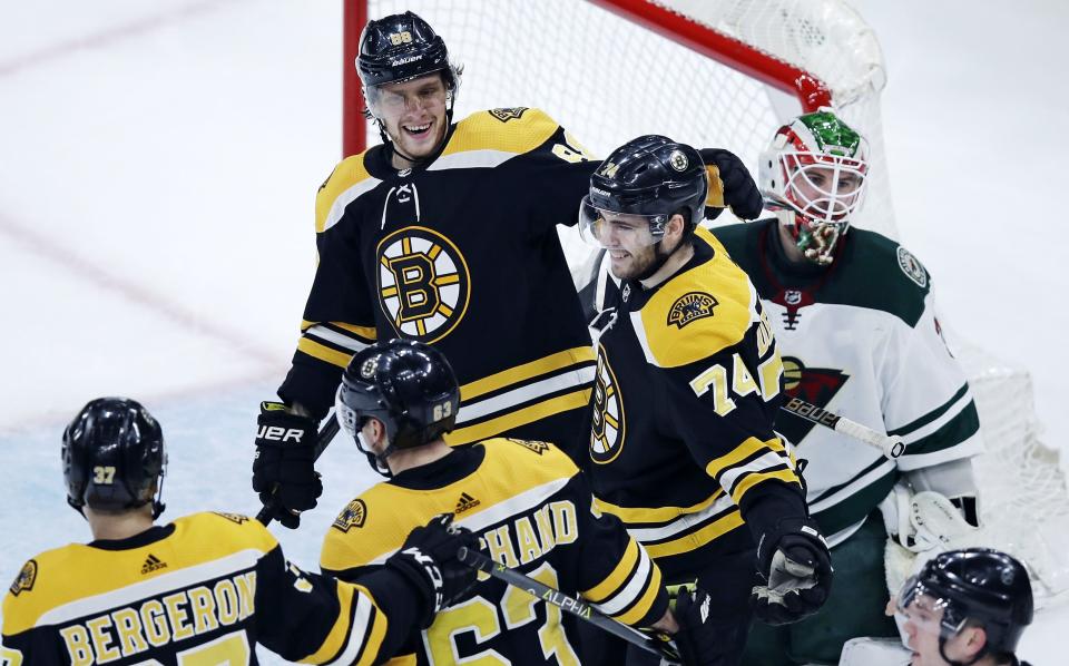 <p>
              Boston Bruins left wing Jake DeBrusk (74) smiles as he is congratulated by teammates after deflecting a shot by Patrice Bergeron off his chest for a goal, beating Minnesota Wild goaltender Alex Stalock, right, during the first period of an NHL hockey game in Boston, Tuesday, Jan. 8, 2019. DeBrusk was credited with the goal. (AP Photo/Charles Krupa)
            </p>