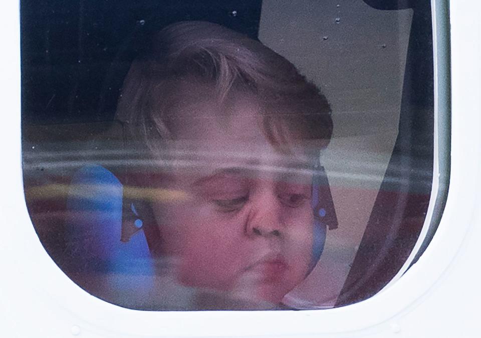 Prince George puts his little nose against the airplane window.