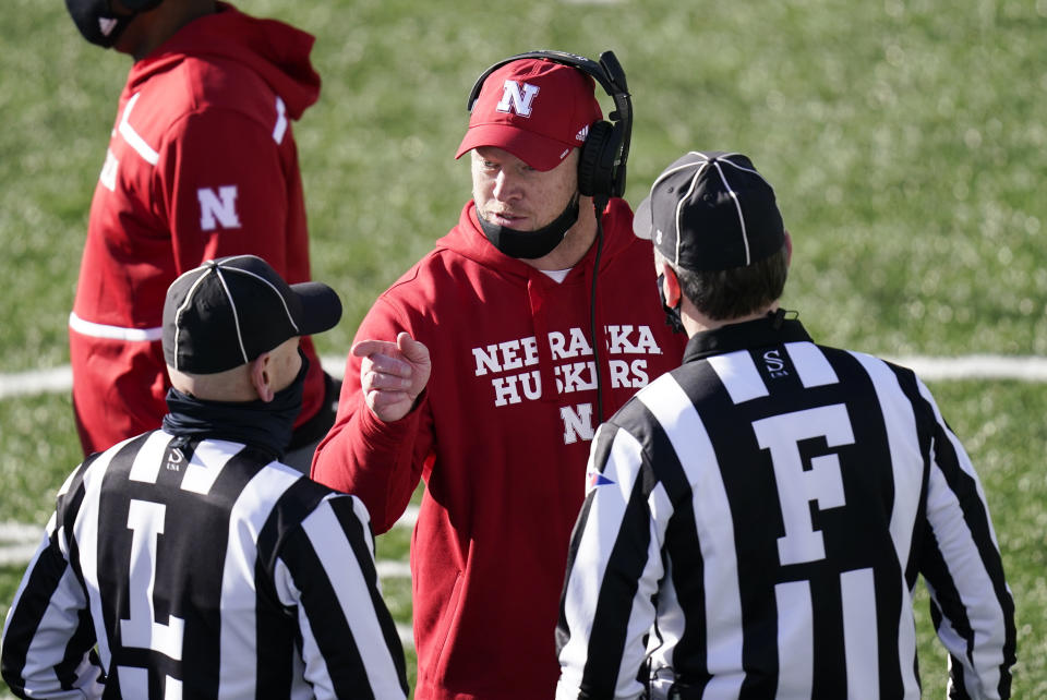 Nebraska head coach Scott Frost, center, questions a call against his team during the first half of an NCAA college football game against Iowa, Friday, Nov. 27, 2020, in Iowa City, Iowa. (AP Photo/Charlie Neibergall)