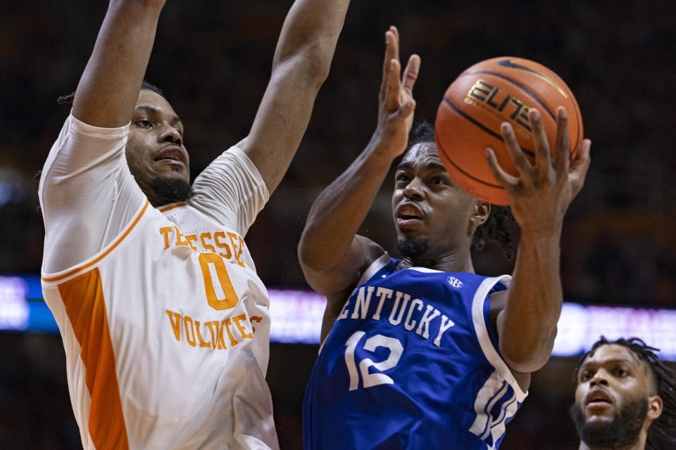Kentucky guard Antonio Reeves (12) shoots past Tennessee forward Jonas Aidoo (0) during the second half of an NCAA college basketball game Saturday, March 9, 2024, in Knoxville, Tenn. (AP Photo/Wade Payne)