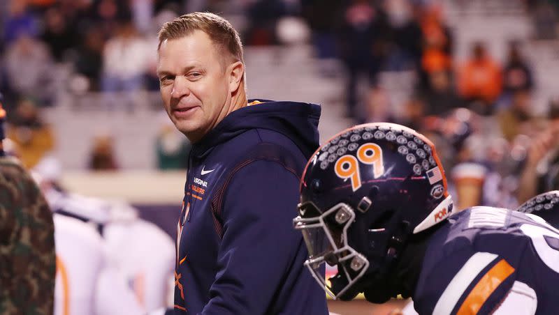 Former Virginia Cavaliers coach Bronco Mendenhall talks with players during warmups with Notre Dame in Charlottesville, Va., on Thursday Nov 13, 2021.