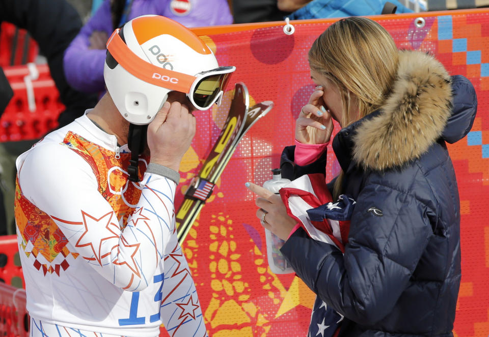 United States' Bode Miller and his wife, Morgan wipe away tears after after finishing third in the men's super-G at the Sochi 2014 Winter Olympics, Sunday, Feb. 16, 2014, in Krasnaya Polyana, Russia. (AP Photo/Christophe Ena)