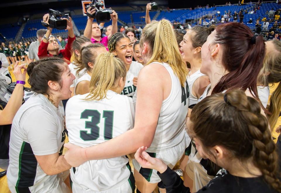 Cedar Park guard Gisella Maul shouts in joy with her teammates while celebrating the 45-40 double-overtime win over Frisco Memorial for the 2022 UIL Class 5A girls state championship. It was the Timberwolves' second straight state title.