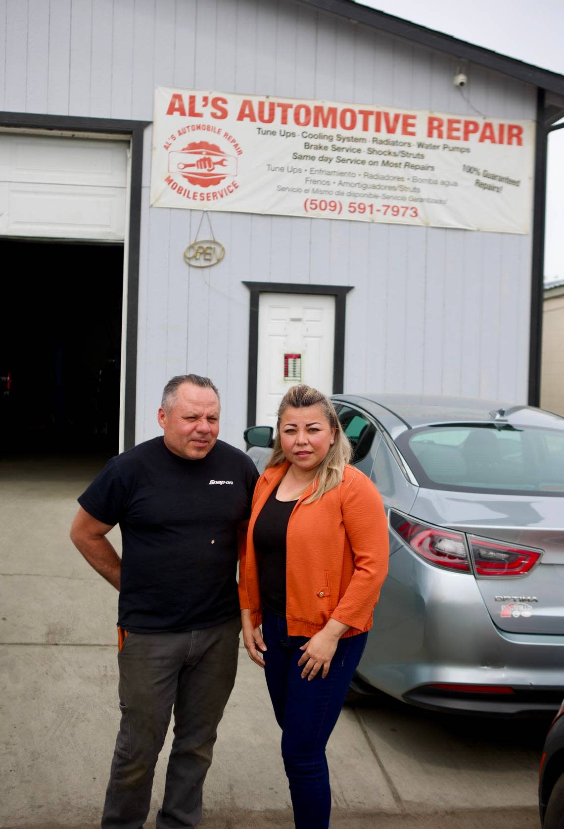 Blanca Garcia and her husband, Alvaro Enriquez, stand in the alley entrance of his business, Al’s Automotive Repair.