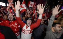 Fans celebrate Team Canada's gold medal win over Sweden in their men's ice hockey game at the Sochi 2014 Winter Olympic Games, at a gathering in Toronto February 23, 2014. REUTERS/Aaron Harris (CANADA - Tags: SPORT ICE HOCKEY OLYMPICS)