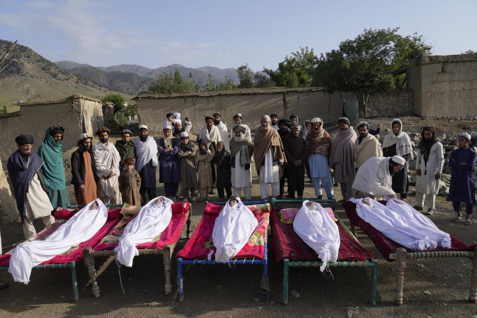 File - Men stand around the bodies of people killed in an earthquake in Gayan village, in Paktika province, Afghanistan, Thursday, June 23, 2022. (AP Photo/Ebrahim Nooroozi, File)