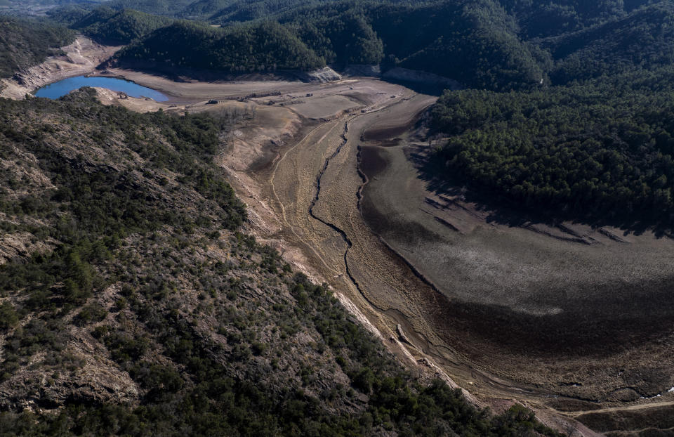 View of Arnius-Boadella reservoir, which is only at 12 percent of its capacity, near Figueras, north of Girona, Spain, Thursday, Jan. 25, 2024. Barcelona and the surrounding area of Spain's northeast Catalonia are preparing to face tighter water restrictions amid a historic drought that has shrunk reservoirs to record lows. Catalonia has recorded below-average rainfall for 40 consecutive months. Experts say that the drought is driven by climate change and that the entire Mediterranean region is forecast to heat up at a faster rate than many other regions in the coming years. (AP Photo/Emilio Morenatti)