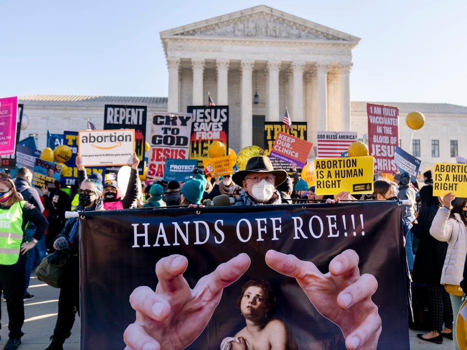 Abortion rights advocates and anti-abortion protesters demonstrate in front of the U.S. Supreme Court, Wednesday, Dec. 1, 2021, in Washington, as the court hears arguments in a case from Mississippi, where a 2018 law would ban abortions after 15 weeks of pregnancy, well before viability.