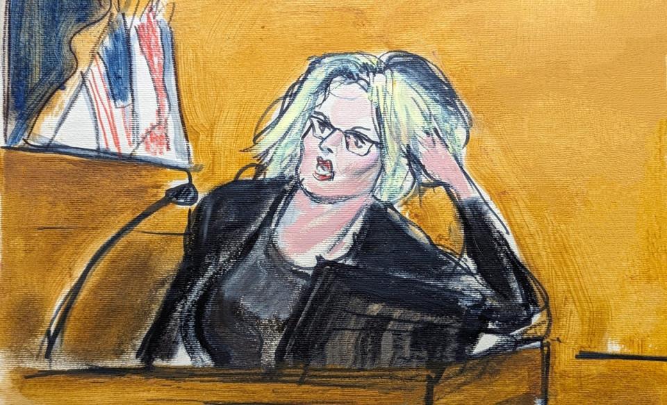 Court sketch shows Stormy Daniels on the witness stand showing jurors how she found Donald Trump posing on his bed in his hotel suite (AP)