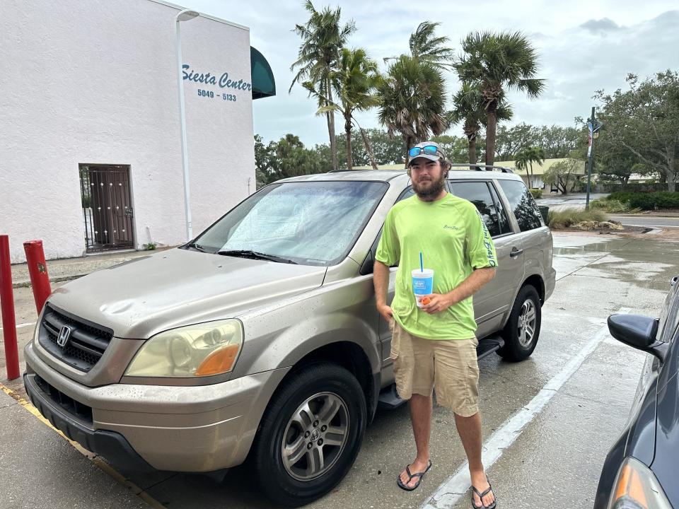 Joseph McGurer said the water was knee deep at 9 a.m near Siesta Key Beach Access 9 when he waded into the storm waters to rescue his girlfriend's car.