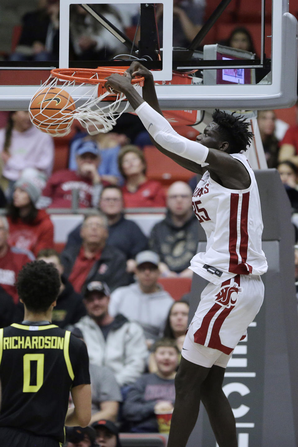 Washington State forward Mouhamed Gueye dunks against Oregon during the second half of an NCAA college basketball game Sunday, Feb. 19, 2023, in Pullman, Wash. Washington State won 68-65. (AP Photo/Young Kwak)